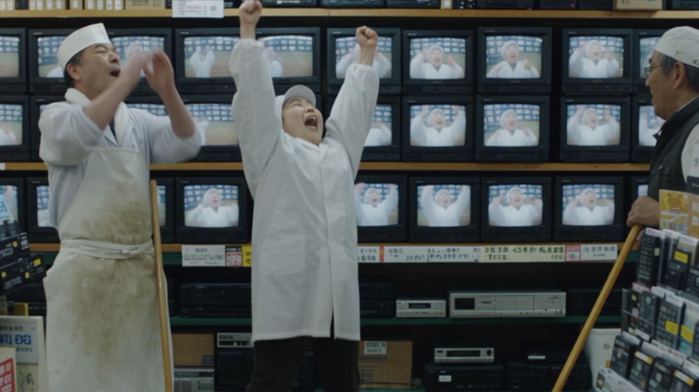 Chef and tuna vendor cheering in the electronics store